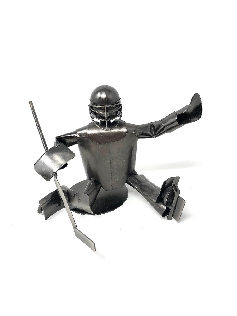 Handmade metal sculpture of a hockey goalie making a save